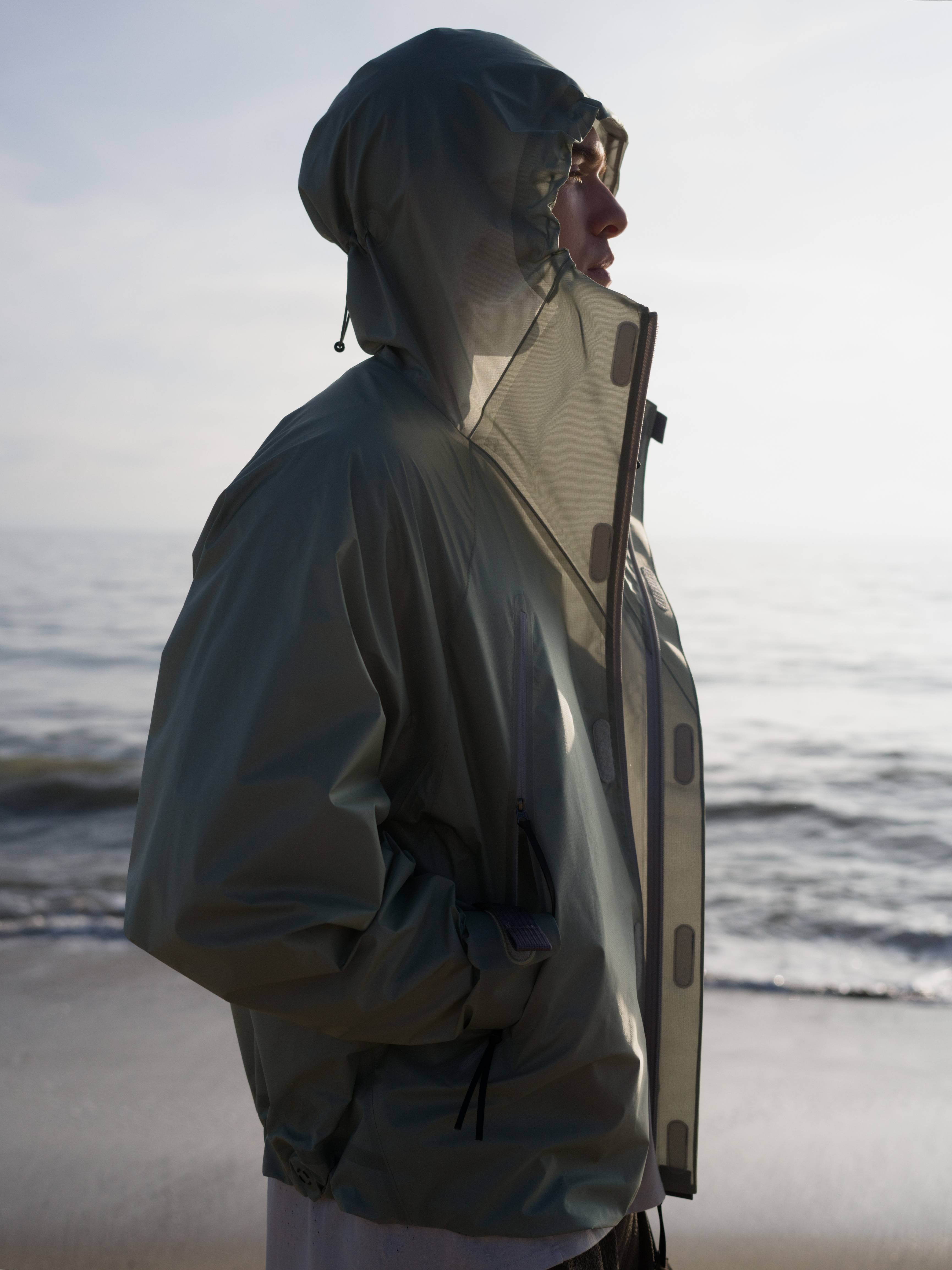 Person wearing a raincoat on a beach